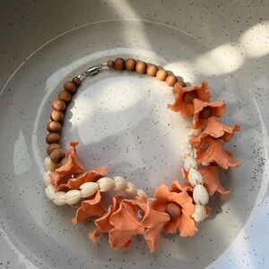 Handmade lava hibiscus with pikake shells car lei